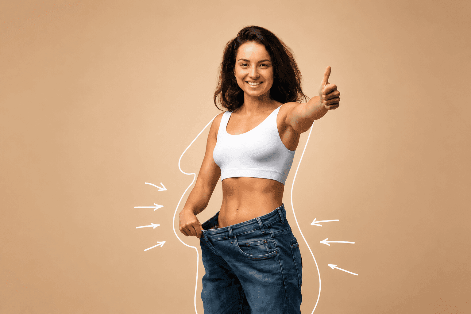 Smiling woman celebrating weight-loss results, giving a thumbs up in jeans that are now too big
